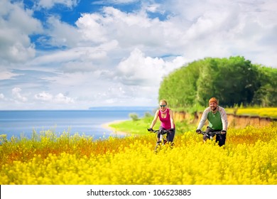 happy couple cycling in canola fields - Powered by Shutterstock