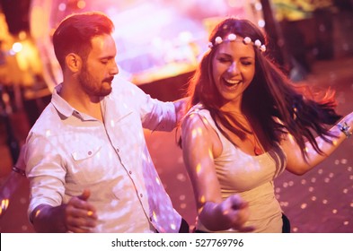 Happy Couple Dancing In Club