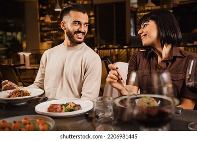 Happy Couple Dining At Restaurant Watching In Each Other Eyes - Engaged Couple On A Date Taking Eye Contact And Eating In The Night At Luxury Restaurant -people, Food And Drink Lifestyle Concept