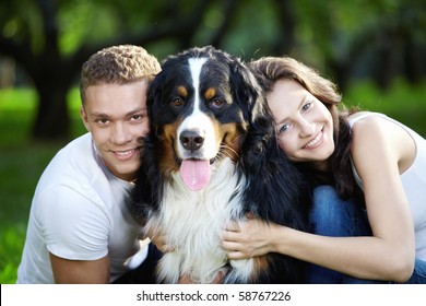 The Happy Couple With A Dog In The Park