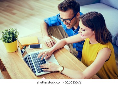 Happy couple doing online shopping together at home