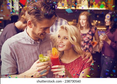 Happy Couple Drinking Cocktails Together Against Flying Colours