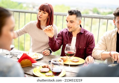 Happy Couple Drinking Wine Together At Rooftop Party In Open Air Villa - Young Friends Eating Food At Restaurant Patio - Cool Life Style Concept On Warm Bright Filter With Focus On Middle Guy