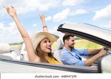 Happy Couple Driving In Convertible