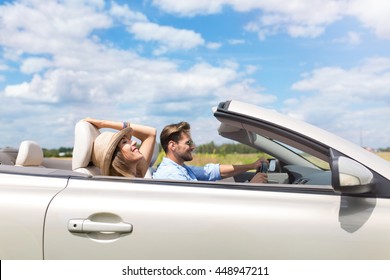 Happy Couple Driving In Convertible