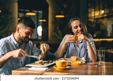 Happy Couple Eating In Fancy Restaurant