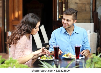 Happy Couple Eating At Terrace