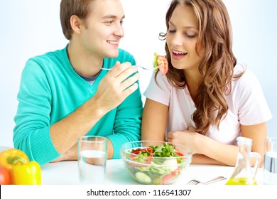 Happy Couple Eating Vegetable Salad