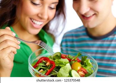 Happy Couple Eating Vegetable Salad