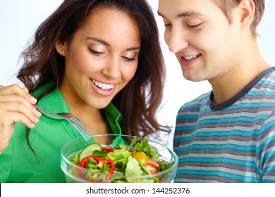 Happy Couple Eating Vegetable Salad