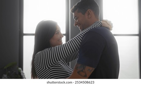 Happy couple embracing in an indoor home setting, radiating love and togetherness - Powered by Shutterstock