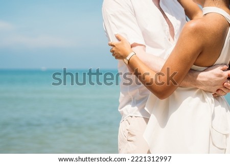 Happy couple embracing together and dancing on tropical beach, Lovers enjoying with honeymoon trip
