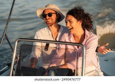 A happy couple enjoying a boat ride on a sunny day, with the man wearing a hat and sunglasses and the woman laughing. - Powered by Shutterstock