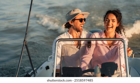 A happy couple enjoying a boat ride on a sunny day, with the man wearing a hat and sunglasses and the woman laughing. - Powered by Shutterstock