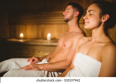 Happy couple enjoying the sauna together at the spa - Powered by Shutterstock