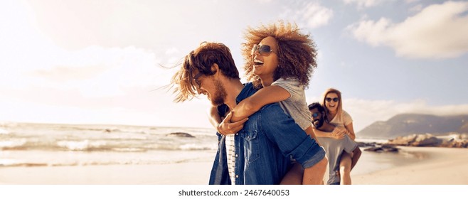 Happy couple enjoying a sunny day at the beach, with the man giving his girlfriend a piggyback ride. Young lovers having a romantic summer vacation, making memories that will last a lifetime. - Powered by Shutterstock