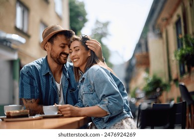 Happy couple enjoying in their love while drinking coffee in a cafe.