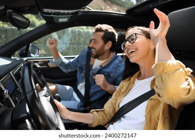 Happy couple enjoying trip together by car, selective focus - Powered by Shutterstock