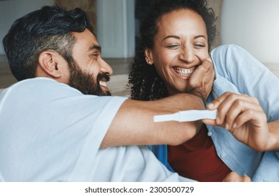 Happy couple, excited and smile for pregnancy test together for happiness, laughing and excitement. Love, funny and a man and pregnant woman looking excited and reading results for a baby at home