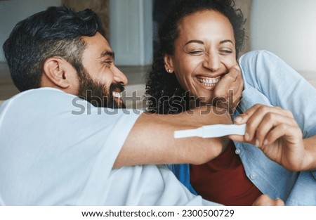 Happy couple, excited and smile for pregnancy test together for happiness, laughing and excitement. Love, funny and a man and pregnant woman looking excited and reading results for a baby at home