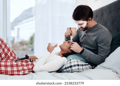 Happy couple, face mask and relax in home for skincare, wellness and weekend fun on bed. Woman, man and skin product in bedroom with brush, application and exfoliation for dermatology with bonding - Powered by Shutterstock