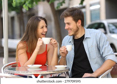 Happy couple or friends flirting talking and drinking in a restaurant terrace - Powered by Shutterstock