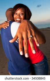 A Happy Couple Gets Engaged On A Beach