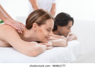 Happy Couple Getting Massage At Spa