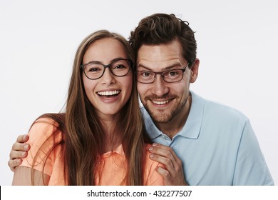 Happy Couple In Glasses Smiling At Camera