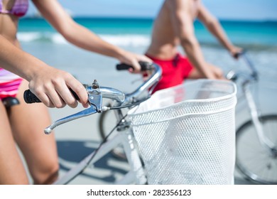 Happy Couple Going On A Bike Ride At The Beach