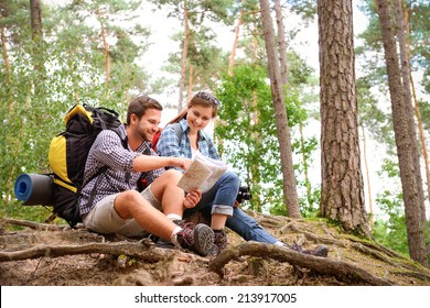 Happy Couple Going On A Hike Together In A Forest