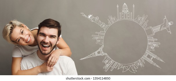 Happy Couple At Grey Backround With Drawn Circle From World Sights Simbols, Copy Space. Happy Travelers Concept