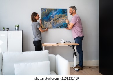 Happy Couple Hanging Painting. Wall Decoration At Home