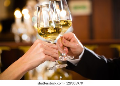 Happy Couple Have A Romantic Date In A Fine Dining Restaurant They Drink Wine And Clinking Glasses, Cheers - Closeup