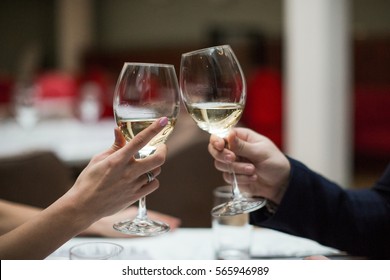 Happy Couple Have A Romantic Date In A Fine Dining Restaurant They Drink Wine And Clinking Glasses, Cheers - Closeup