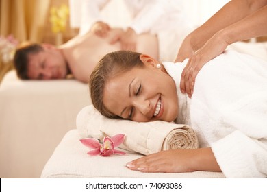 Happy Couple Having Back Massage In Day Spa.