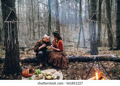 happy-couple-having-dinner-forest-260nw-561851227.jpg