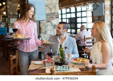 Happy couple having dinner at rural restaurant and drinking wine. Focus on the young man - Shutterstock ID 479936554