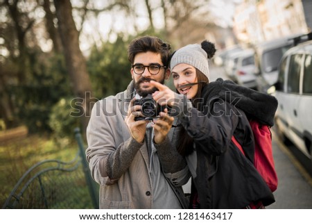 Similar – couple taking selfie in the street