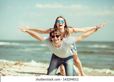 Happy Couple Having Fun On The Beach