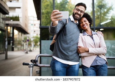 Happy Couple Having Fun And Taking A Selfie. Smiling People Enjoying City Life.