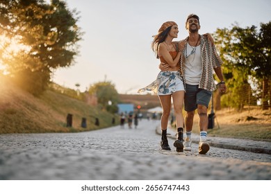 Happy couple having fun while going on summer music festival. Copy space. 
