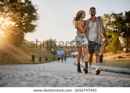 Happy couple having fun while going on summer music festival. Copy space. 