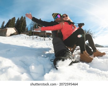 Happy Couple Having Fun With Wood Vintage Sledding On Snow High Mountains - Soft Focus On Girl Face