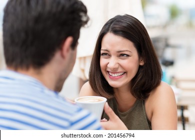 Happy Couple Having A Great Time Talking Over A Cup Of Coffee