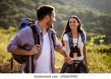 Happy couple is hiking in mountain.