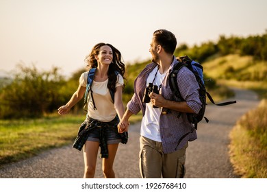 Happy couple is hiking in mountain.