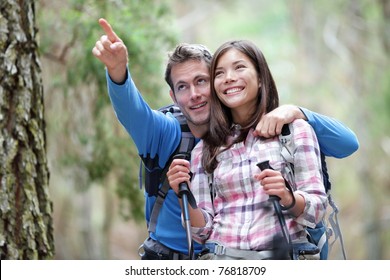 Happy Couple Hiking Outdoors In Forest. Active Young Asian Woman Hiker And Caucasian Man.