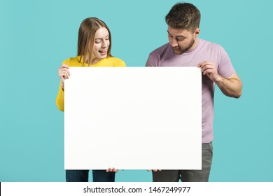 Happy Couple Holding Blank Sign