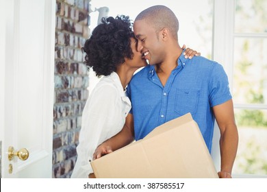 Happy Couple Holding Box Out Of Their House